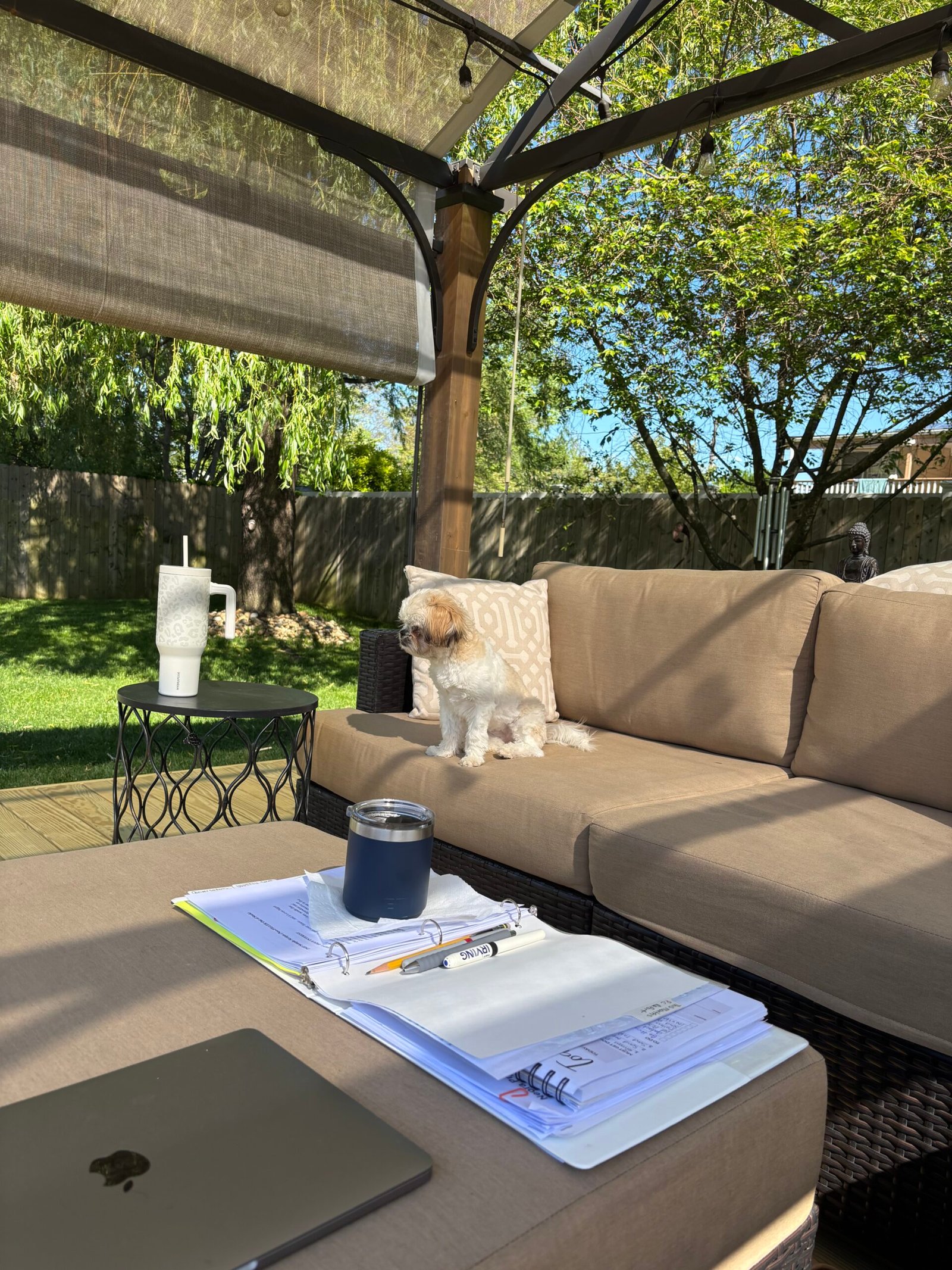 backyard patio seating area surrounded by garden